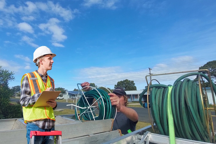 
After gutter rinsing, portstephens gutter cleaner organizes his hose system.