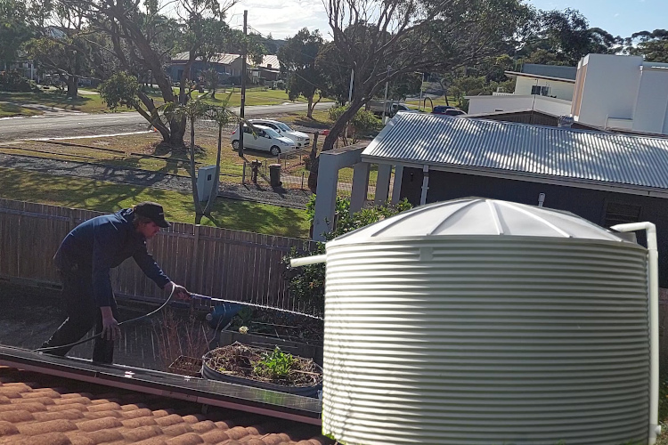 
portstephens Gutter Expert Rinses Gutters at Rainwater-Reliant Premises
